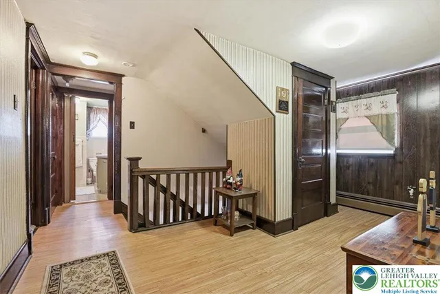 a living room with a bed furniture and a flat tv screen