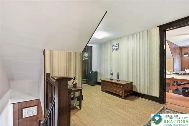 a spacious bedroom with a large bed and a chandelier