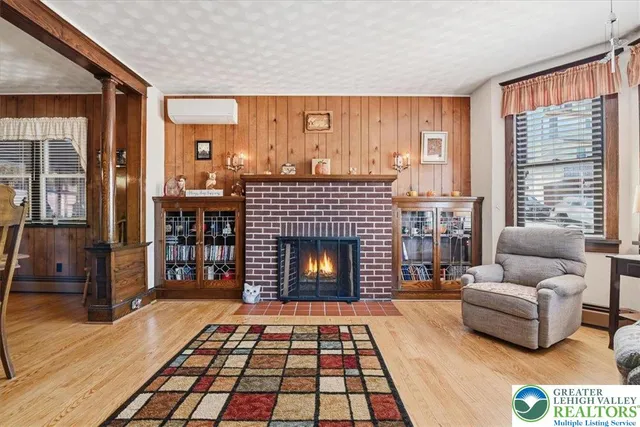 a living room with furniture a rug and a fireplace