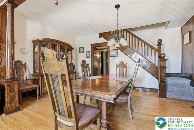 a view of a livingroom with furniture staircase and hallway