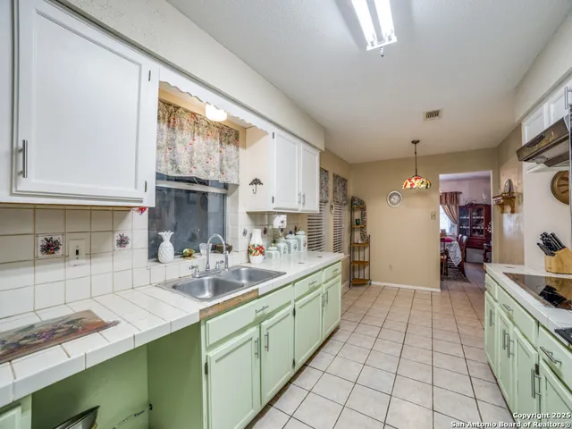 a kitchen with a sink and cabinets