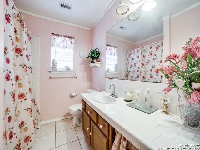 a bath room with a sink and a mirror