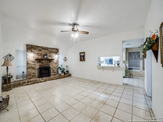a view of a livingroom with a fireplace a chandelier a windows and closet