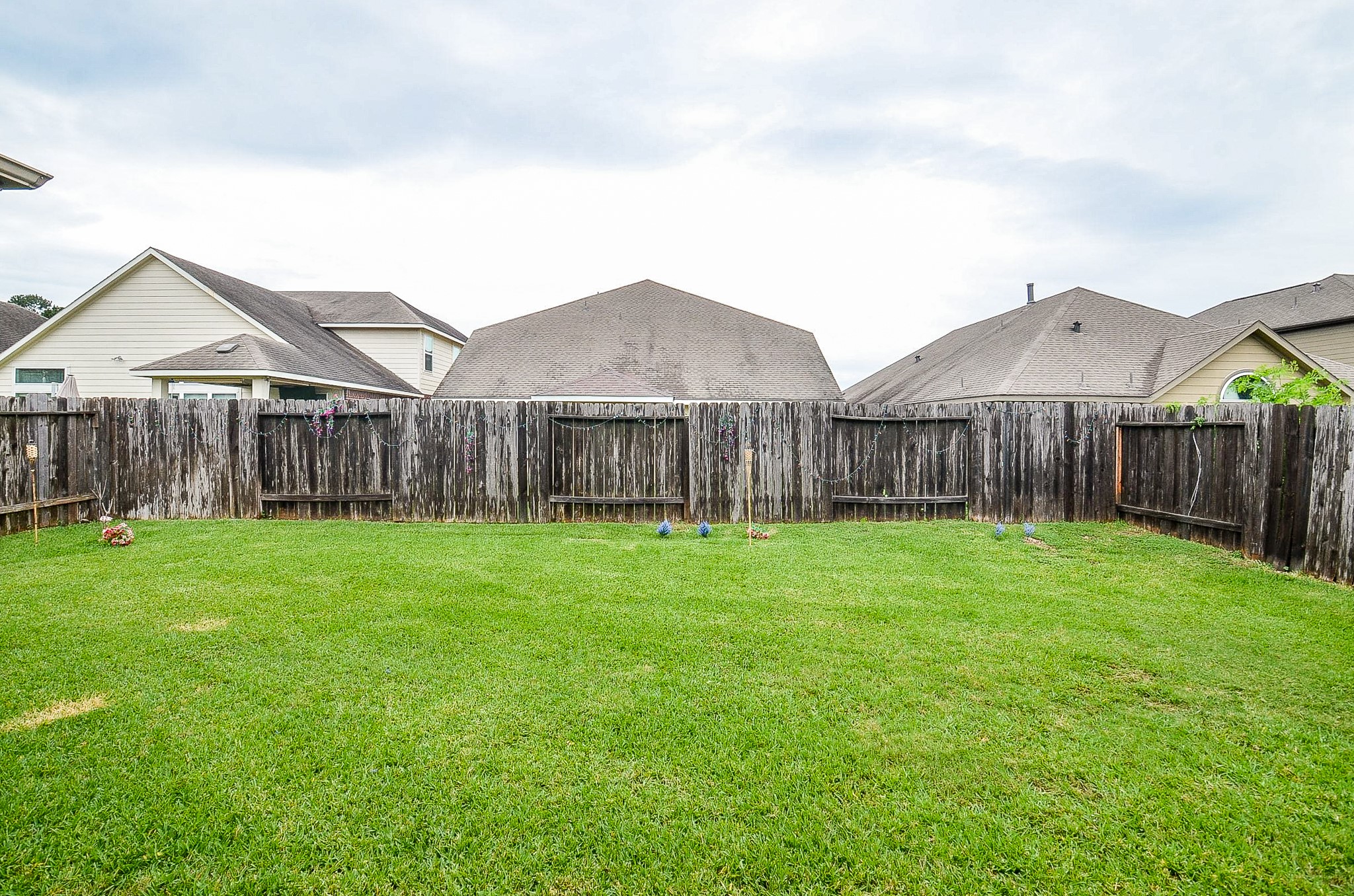 7042 Sliding Rock Circle Spring, TX 77379 - Photo 29 of 36 Expansive backyard with lush green lawn—perfect for outdoor activities and relaxation.