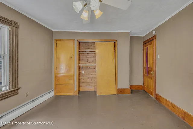 an empty room with windows and closet