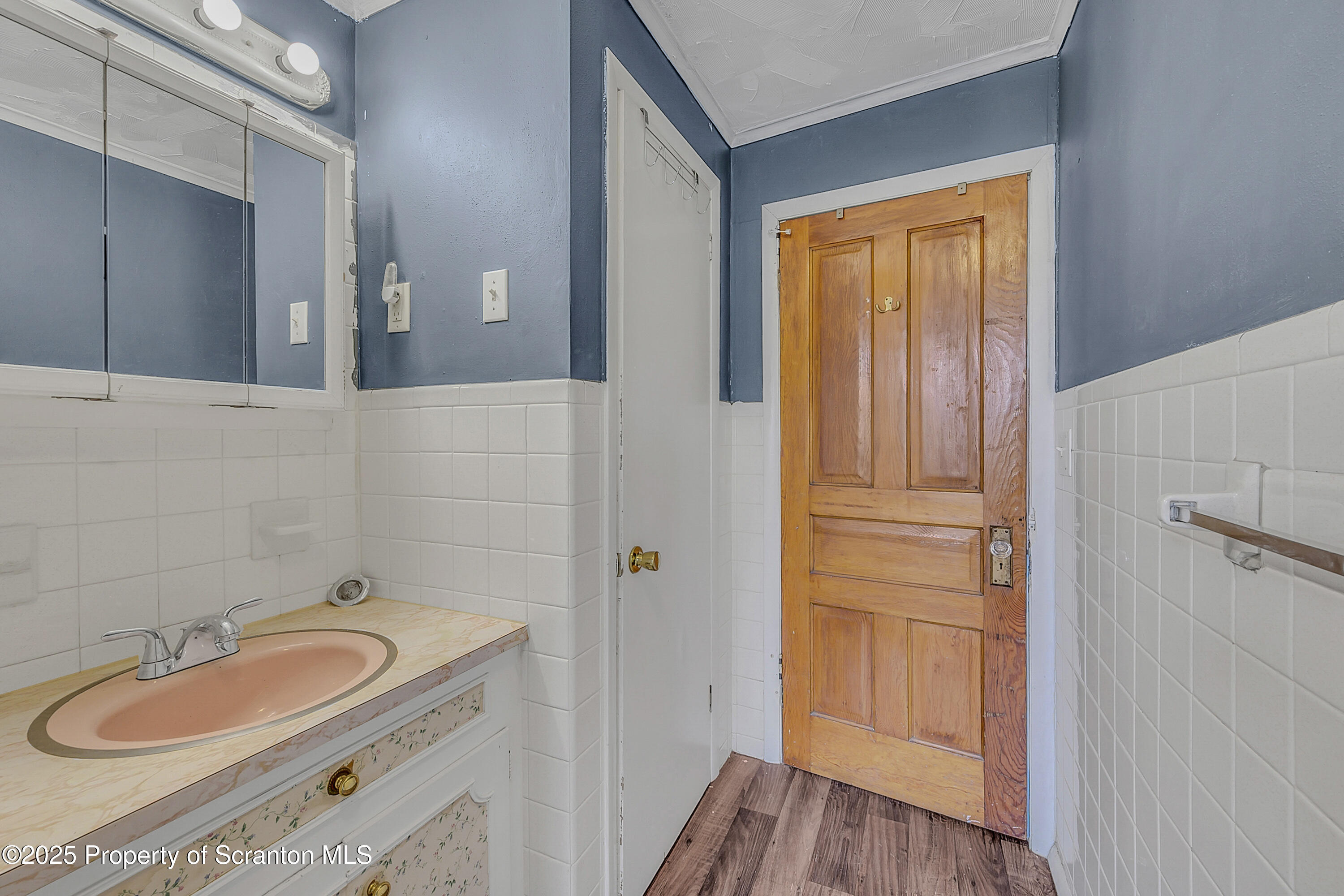 1202 Main Street Dickson City, PA 18519 - Photo 19 of 30 a bathroom with a granite countertop sink and a mirror