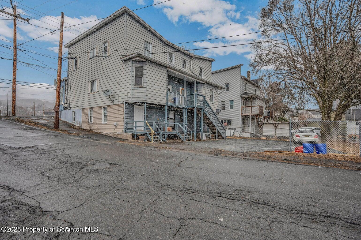 1202 Main Street Dickson City, PA 18519 - Photo 21 of 30 a front view of a house with a road