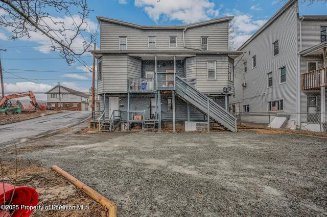 a view of a house with wooden deck
