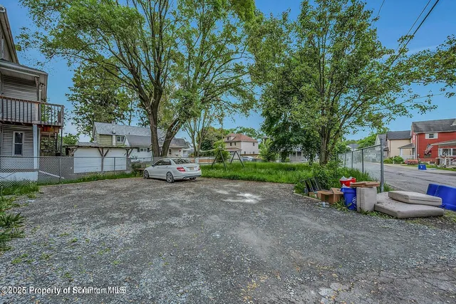 a green field with trees in the background