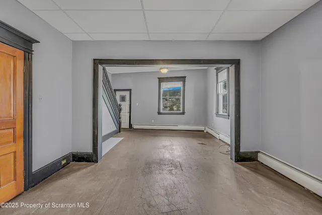 an empty room that has a stove and a window