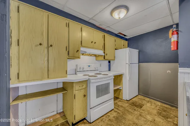 a utility room with cabinets washer and dryer