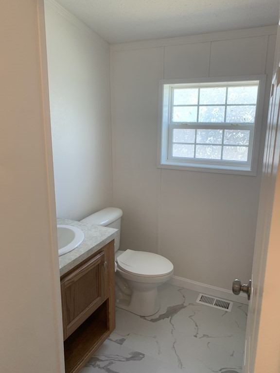 557 Southwest Cutoff, Unit 38 Worcester, MA 01607 - Photo 11 of 20 a white toilet sitting next to a window in a bathroom