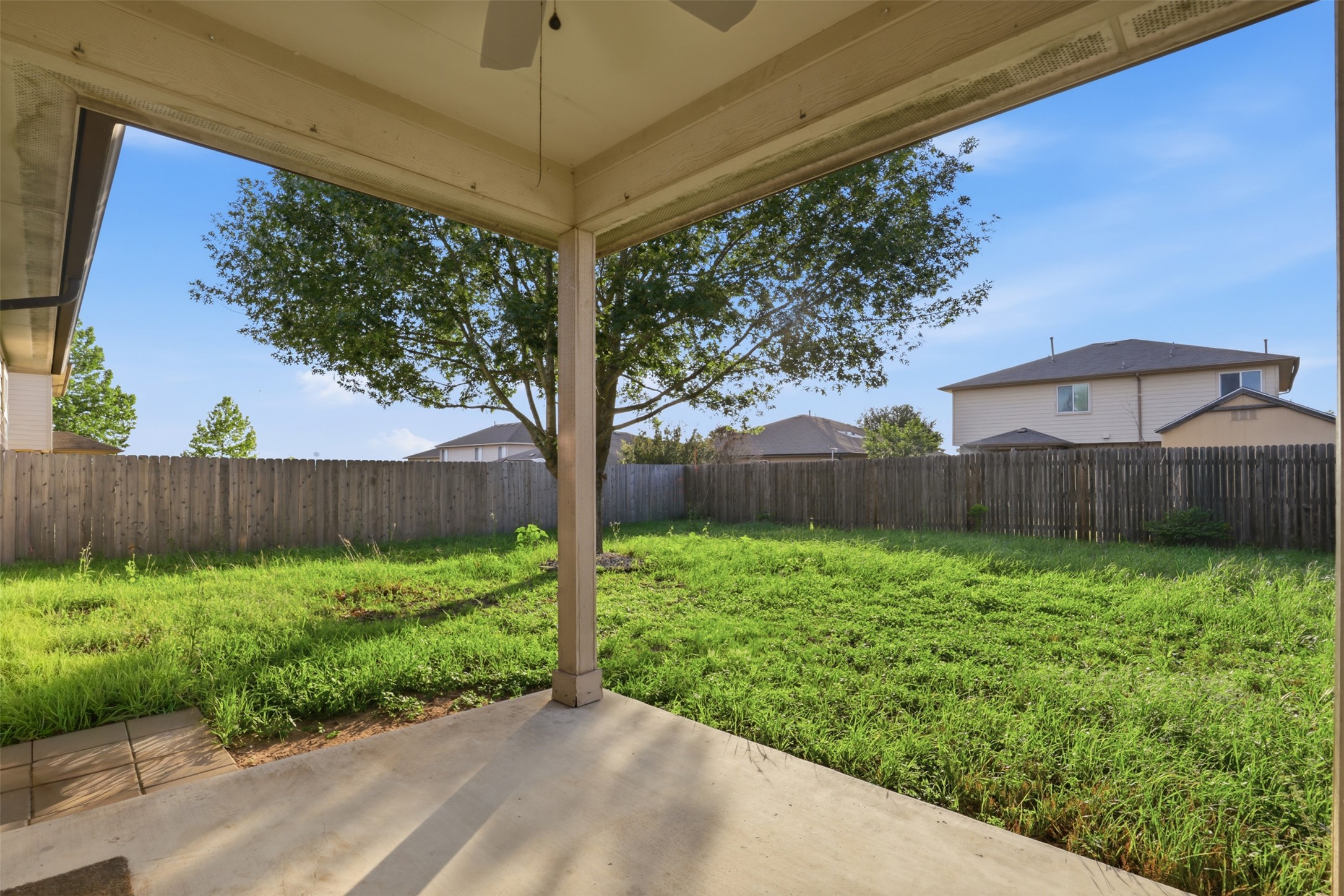 448 Nottingham Loop Kyle, TX 78640 - Photo 15 of 16 Covered patio with a ceiling fan, concrete flooring, and a spacious green lawn