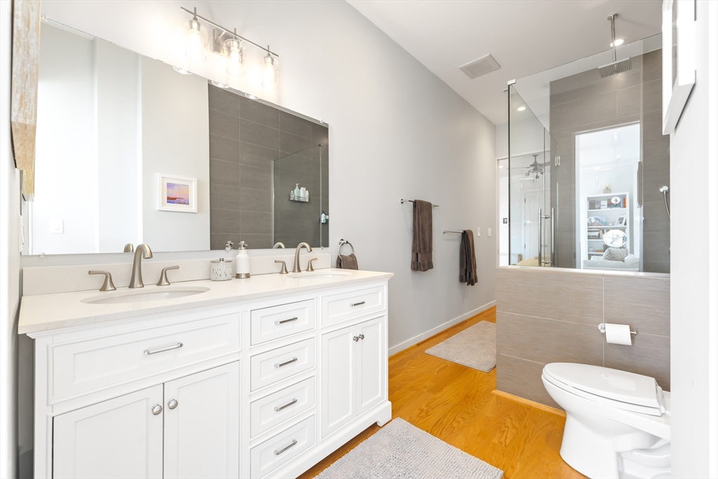 36 A Street, Unit 5C Boston, MA 02127 - Photo 13 of 25 a spacious bathroom with a granite countertop sink toilet and a tub