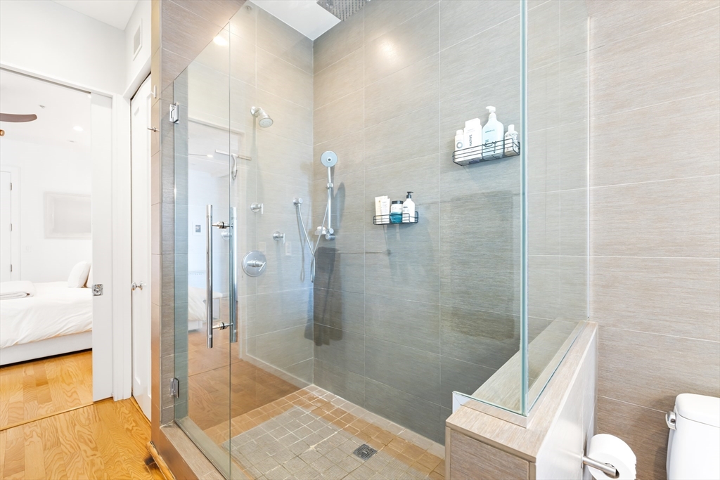 36 A Street, Unit 5C Boston, MA 02127 - Photo 14 of 25 a bathroom with a shower and a toilet