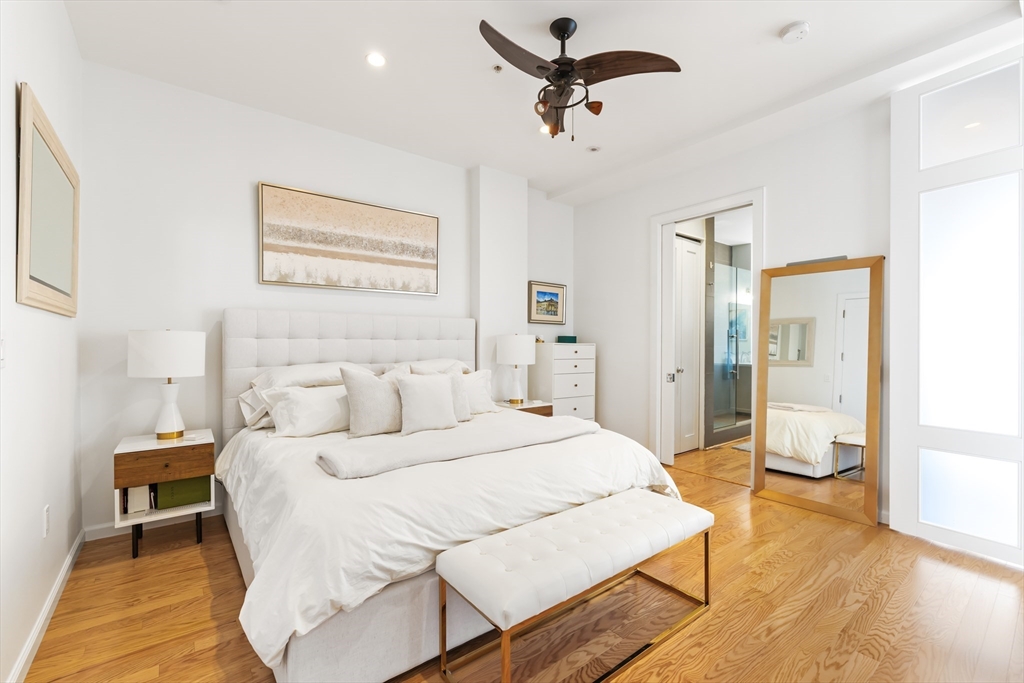 36 A Street, Unit 5C Boston, MA 02127 - Photo 15 of 25 a bedroom with a bed and wooden floor