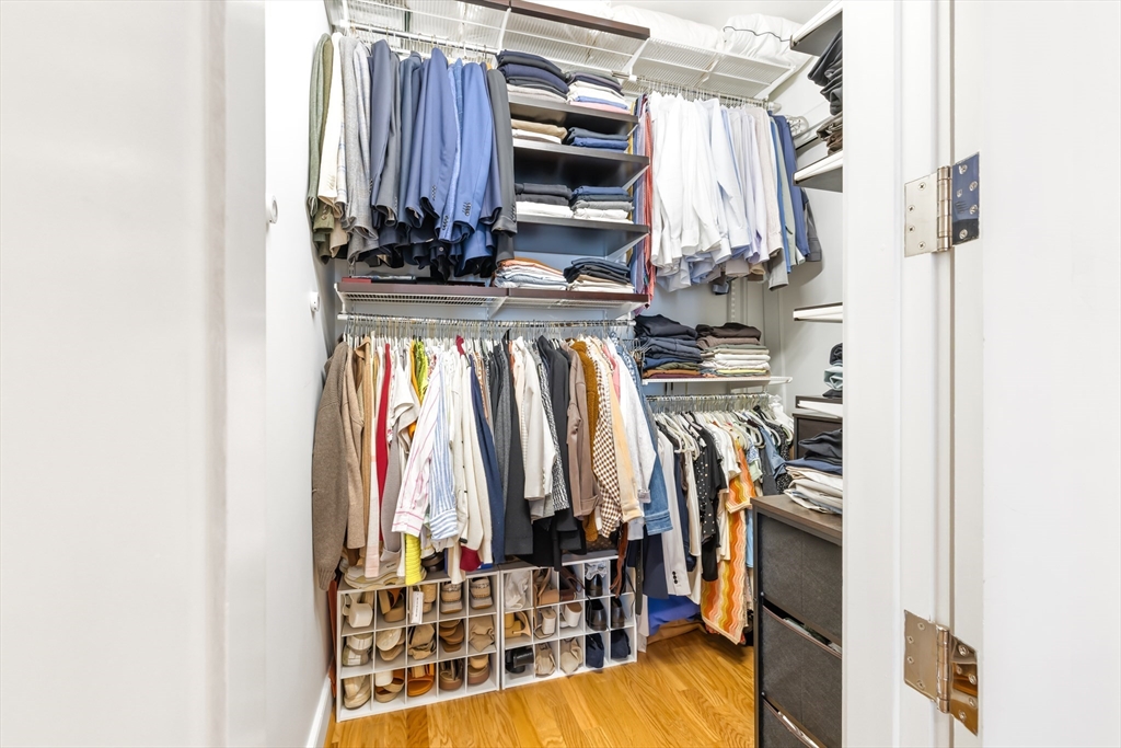 36 A Street, Unit 5C Boston, MA 02127 - Photo 18 of 25 a view of walk in closet with clothes and shoes
