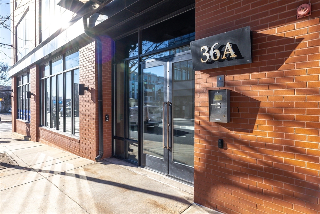 36 A Street, Unit 5C Boston, MA 02127 - Photo 25 of 25 a view of a brick building with a door and windows