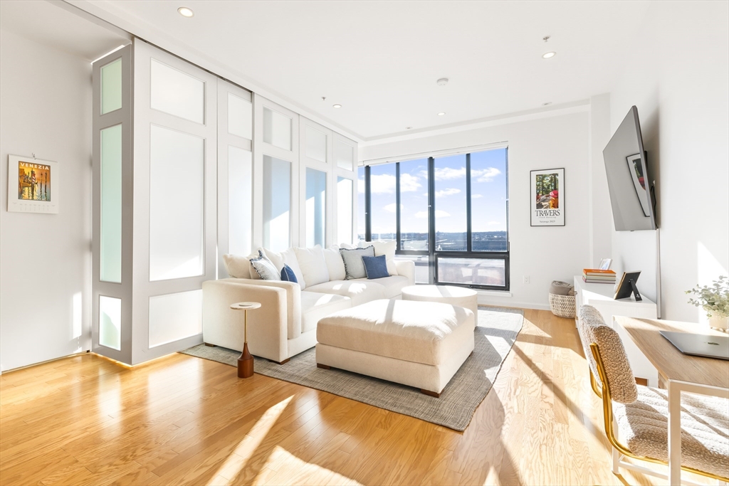 36 A Street, Unit 5C Boston, MA 02127 - Photo 6 of 25 a spacious bedroom with a large bed and a large window