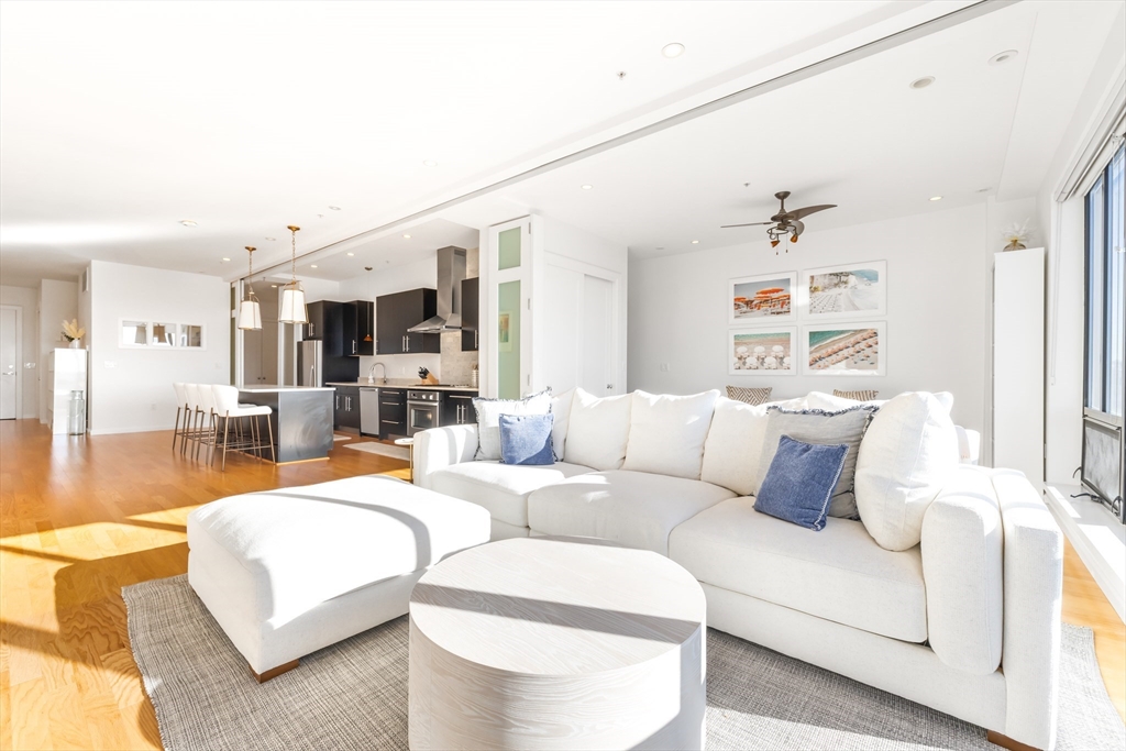36 A Street, Unit 5C Boston, MA 02127 - Photo 7 of 25 a living room with furniture and wooden floor