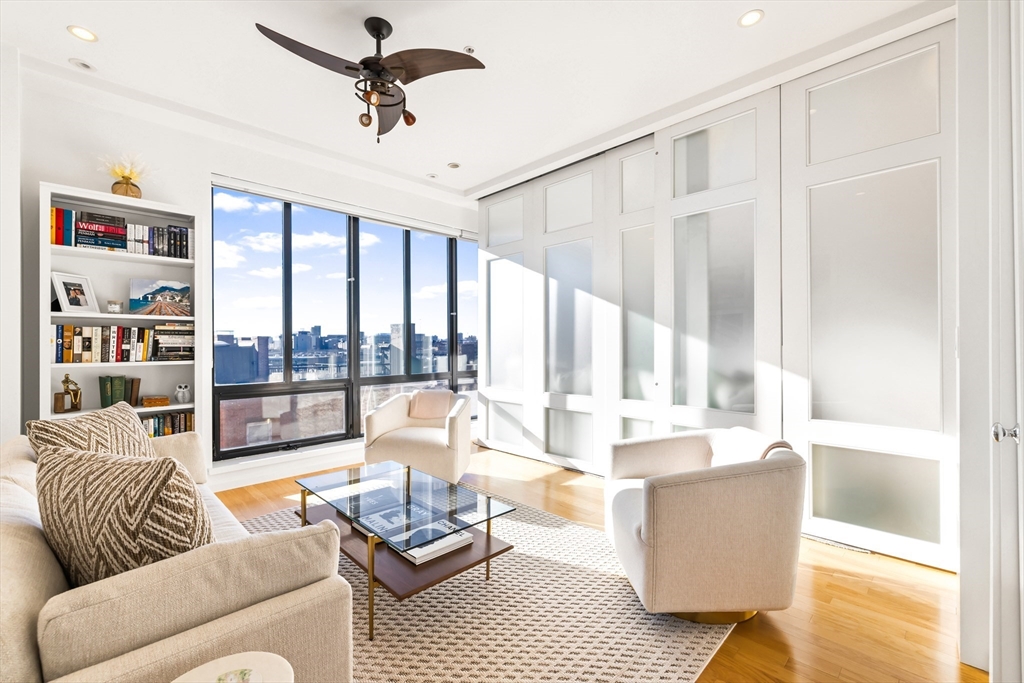 36 A Street, Unit 5C Boston, MA 02127 - Photo 8 of 25 a living room with furniture and a large window