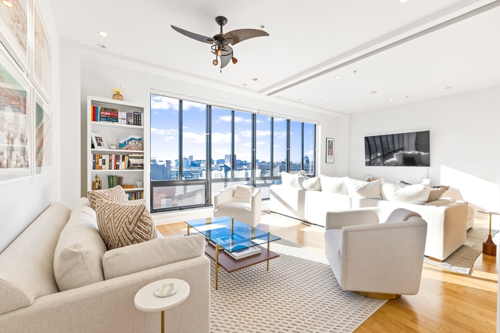 36 A Street, Unit 5C Boston, MA 02127 - Photo 9 of 25 a living room with furniture and a flat screen tv