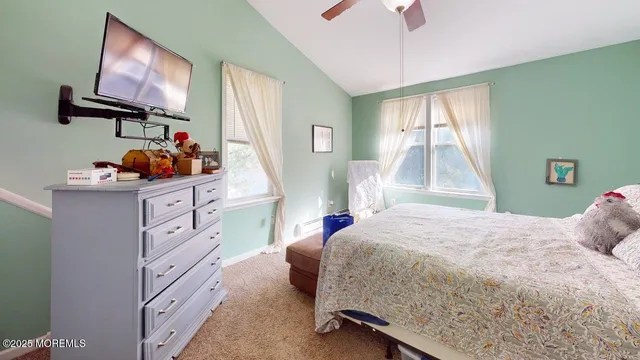 a bedroom with a bed and flat screen tv