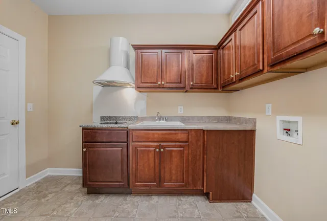 a large kitchen with stainless steel appliances kitchen island granite countertop a large counter top stainless steel appliances a stove a sink and a refrigerator