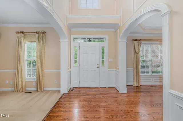 a view of an entryway with wooden floor and stairs