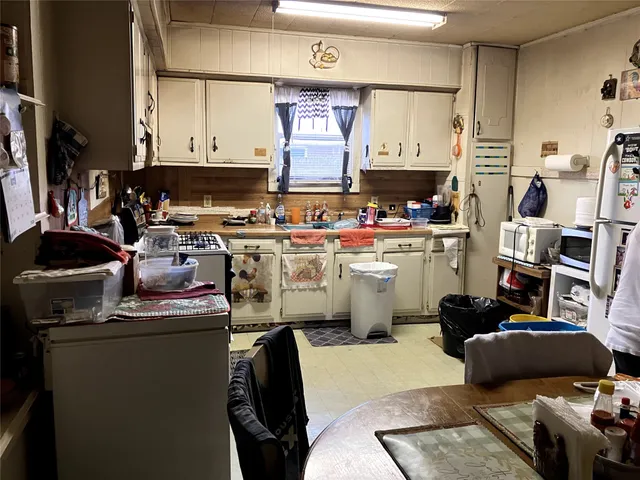 a kitchen with a stove a refrigerator and a sink