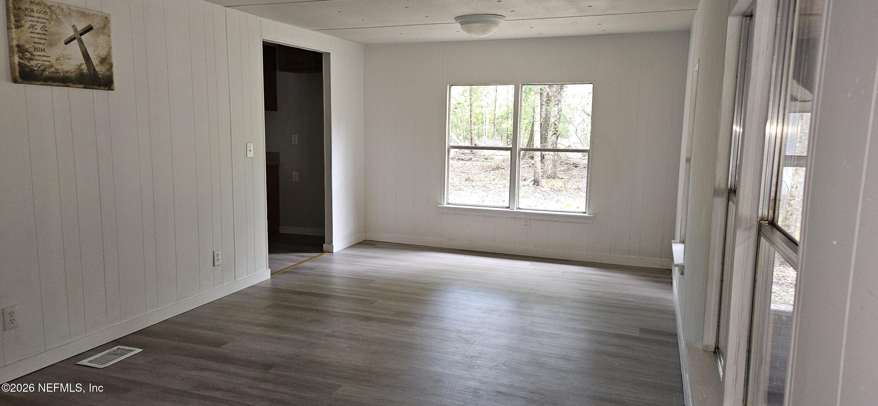 5363 Kilcrease Road Jacksonville, FL 32234 - Photo 6 of 29 an empty room with wooden floor and windows