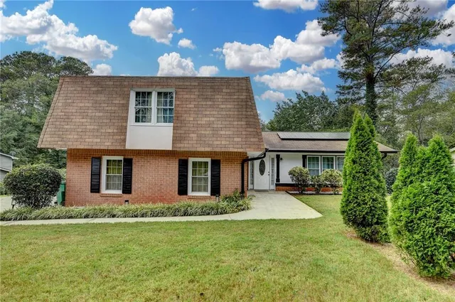 a front view of house with yard and green space