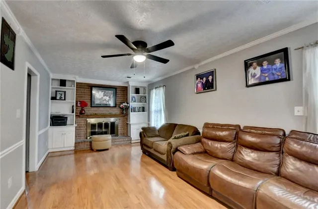 a living room with furniture a flat screen tv and a fireplace