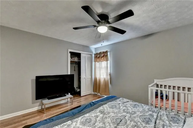 a bedroom with bed and flat screen tv