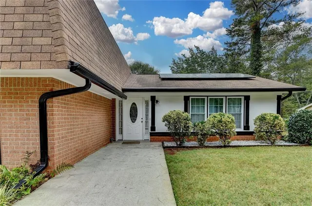 a front view of house with yard and outdoor seating