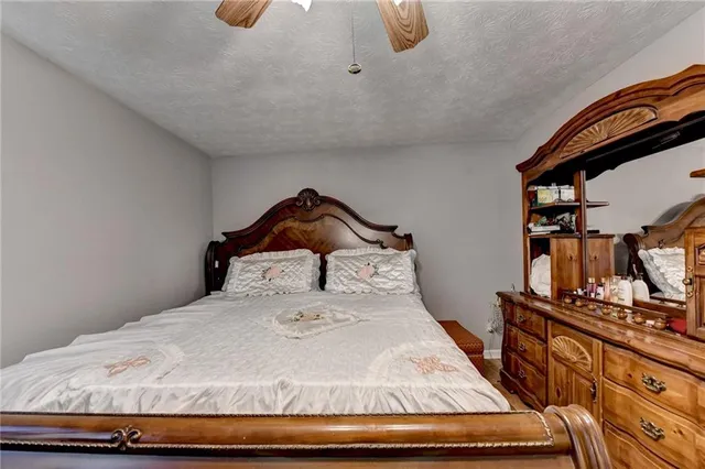 a bedroom with a bed and dresser