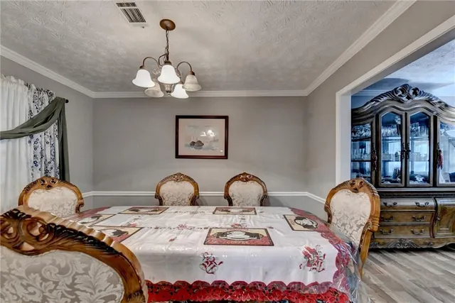 a bedroom with bed and a chandelier