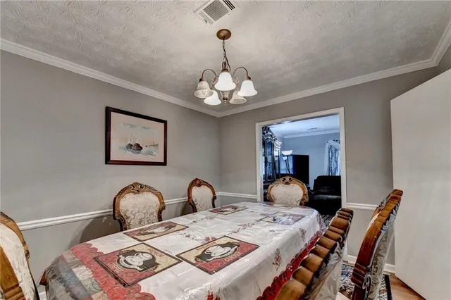 a bedroom that has a bed and a chandelier