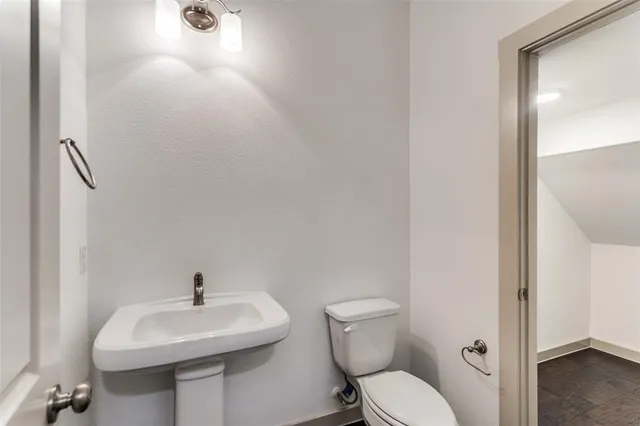 a bathroom with a sink toilet and a mirror