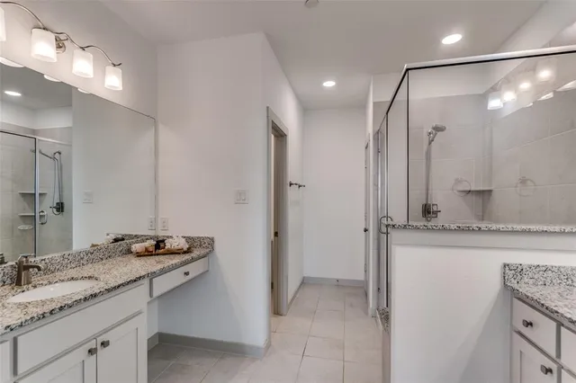a bathroom with a granite countertop sink mirror and double