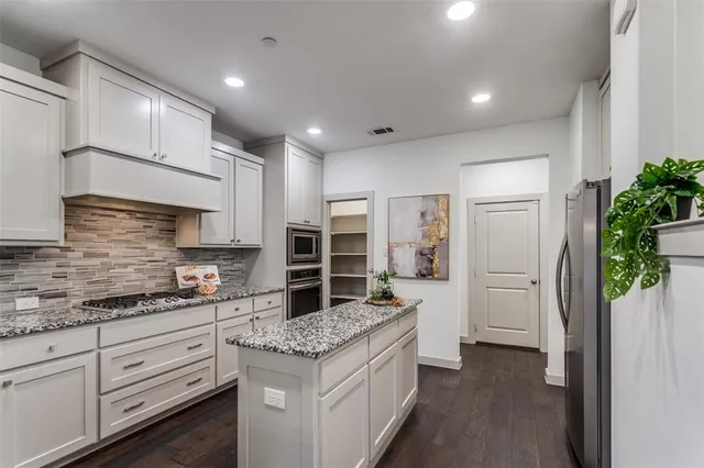 a kitchen with a sink and refrigerator