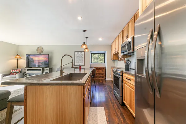 a kitchen with cabinets a sink and appliances