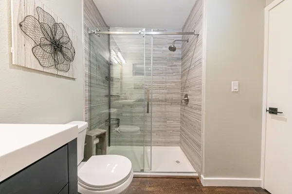 a bathroom with a toilet and a shower