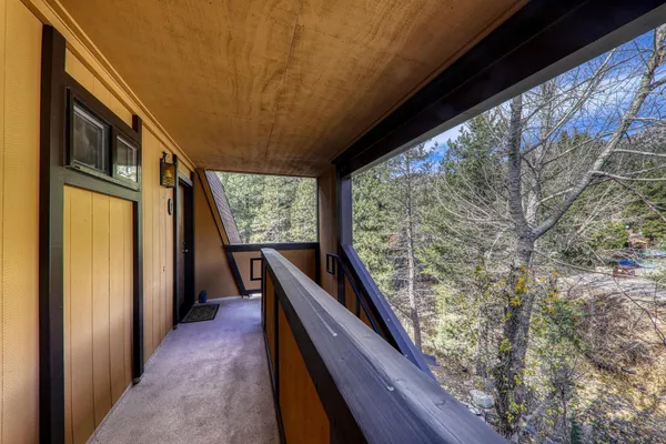 a view of deck with furniture and large windows