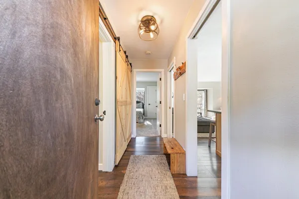 a view of hallway with wooden floor