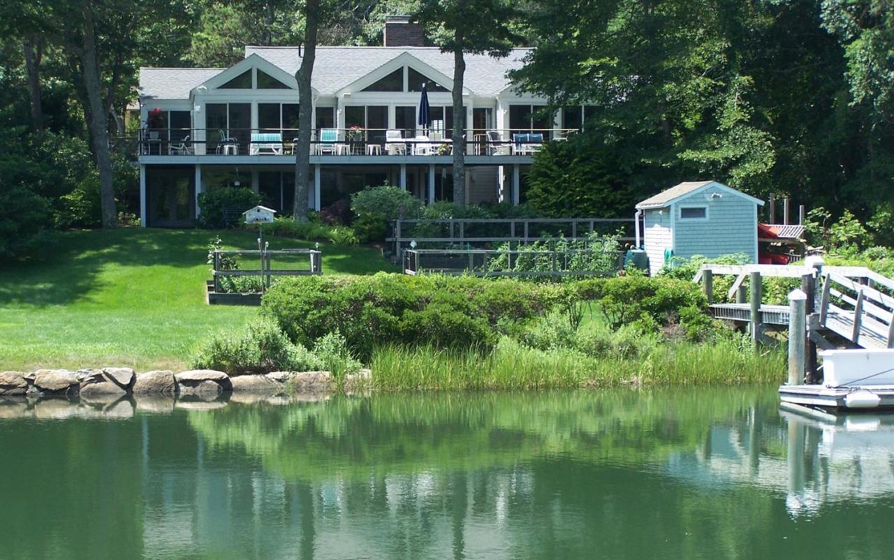 a aerial view of a house with a garden and lake view