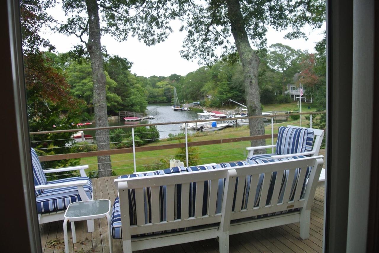 118 Wading Place Road Mashpee, MA 02649 - Photo 15 of 32 a view of a wooden deck and a yard with swimming pool
