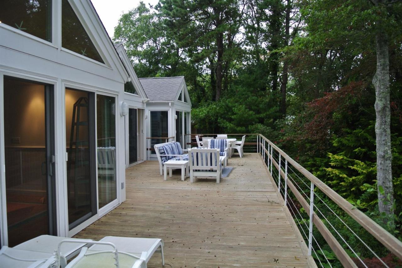 118 Wading Place Road Mashpee, MA 02649 - Photo 16 of 32 a view of a patio with a table and chairs