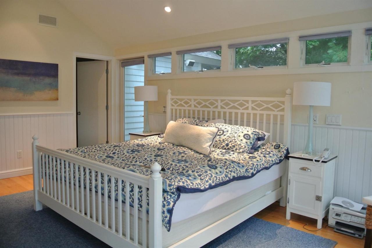 118 Wading Place Road Mashpee, MA 02649 - Photo 19 of 32 a bed sitting in a bedroom next to a window