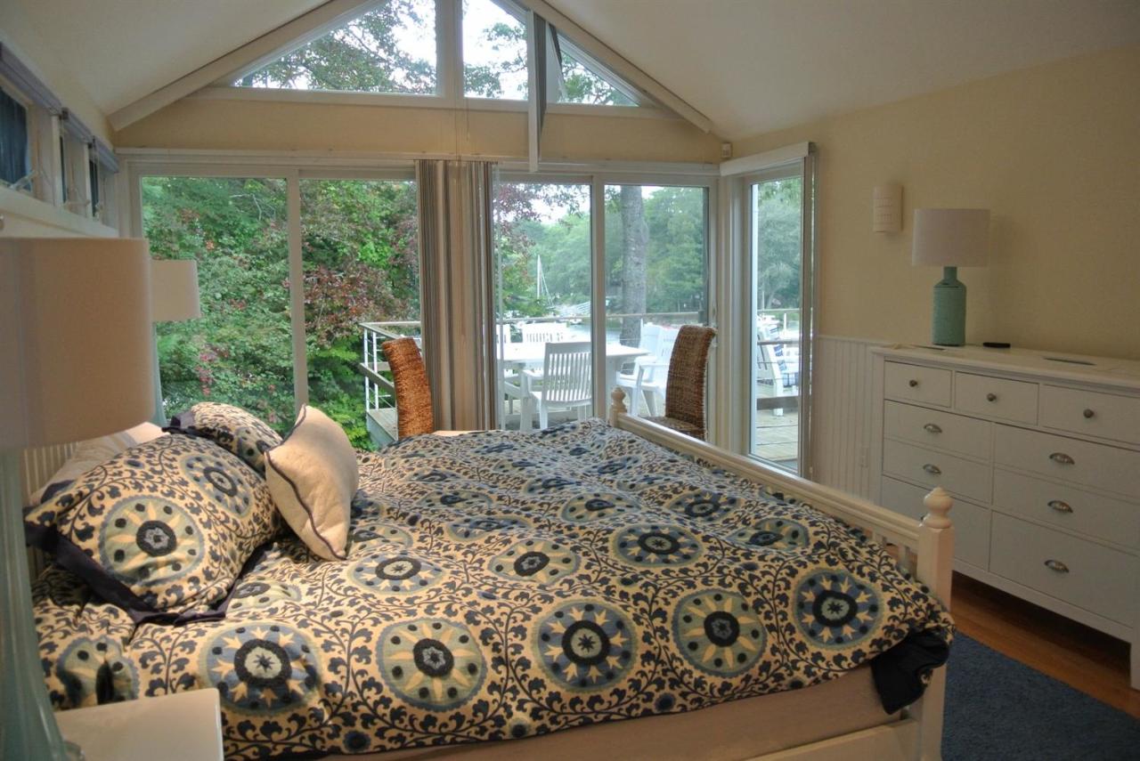 118 Wading Place Road Mashpee, MA 02649 - Photo 20 of 32 a bed sitting in a bedroom next to a window